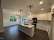 Bright kitchen with granite island, stainless appliances, and white cabinetry overlooking dining area at 141 Ruskin Dr, Smithfield, NC 27577