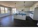 Spacious kitchen with white cabinets, stainless appliances, and a large center island at 141 Ruskin Dr, Smithfield, NC 27577