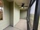 Outdoor screened porch with ceiling fan and green siding offers a cool spot to relax at 141 Ruskin Dr, Smithfield, NC 27577