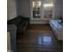The bedroom features hardwood floors, a sofa, and a bed with natural light at 1421 Blanton St, Rocky Mount, NC 27803