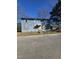 Two-story home featuring light blue siding and a modest front yard under a clear blue sky at 1421 Blanton St, Rocky Mount, NC 27803