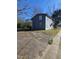 Two story home with light blue siding next to a cracked and worn concrete parking area under a blue sky at 1421 Blanton St, Rocky Mount, NC 27803