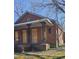 Red brick home with covered front porch, boarded up windows and overgrown landscaping at 1421 Blanton St, Rocky Mount, NC 27803