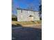 The front exterior shows a two-story blue house with boarded up windows at 1421 Blanton St, Rocky Mount, NC 27803