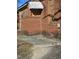 Red brick home's side exterior shows boarded windows, overgrown landscaping and brick detail at 1421 Blanton St, Rocky Mount, NC 27803