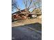 Street view of the red brick home with covered porch, boarded windows and attached carport at 1421 Blanton St, Rocky Mount, NC 27803