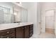 Bathroom with dark wood cabinets, large mirror, and separate shower area at 15 Woodworkers Way, Clayton, NC 27520