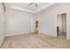 Bedroom with carpet and ceiling fan has adjacent bathroom and stairwell entrance at 15 Woodworkers Way, Clayton, NC 27520