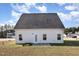 Exterior shot of house featuring concrete patio, white siding and yard under a bright blue sky at 15 Woodworkers Way, Clayton, NC 27520