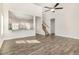 Inviting living area features wood flooring and an open floor plan with a kitchen view and staircase at 15 Woodworkers Way, Clayton, NC 27520