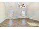 Bright living room with wood-look floors, ceiling fan and walk-out access at 15 Woodworkers Way, Clayton, NC 27520