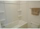 Bright bathroom featuring a white bathtub, toilet, towel rack and shelving at 1725 Mallard Trace Dr, Wendell, NC 27591