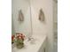Bathroom with single sink vanity, mirror, shower, and white tile at 1725 Mallard Trace Dr, Wendell, NC 27591