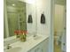 Bathroom features double sinks, framed mirror, updated lighting, and walk-in shower at 1725 Mallard Trace Dr, Wendell, NC 27591