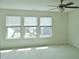Sunlit bedroom with a ceiling fan and a backyard view through the multiple windows at 1725 Mallard Trace Dr, Wendell, NC 27591