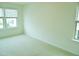 Bedroom features a neutral carpet, large windows, and natural light at 1725 Mallard Trace Dr, Wendell, NC 27591