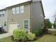 Exterior view of townhome with side entry garage and well manicured landscape at 1725 Mallard Trace Dr, Wendell, NC 27591