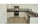 Bright kitchen featuring modern appliances, sleek countertops, and wood flooring at 1725 Mallard Trace Dr, Wendell, NC 27591