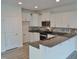Modern kitchen with white cabinets, granite countertops, and stainless steel appliances at 1725 Mallard Trace Dr, Wendell, NC 27591
