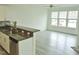 Open-concept kitchen flowing into living area, with granite countertops and ample natural light at 1725 Mallard Trace Dr, Wendell, NC 27591