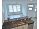 Open kitchen with bar seating, modern appliances, and a view into the living area at 1725 Mallard Trace Dr, Wendell, NC 27591