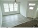 Bright living room features hardwood floors, modern ceiling fan and plentiful natural light from the windows at 1725 Mallard Trace Dr, Wendell, NC 27591