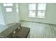 Bright living room features hardwood floors, modern ceiling fan and plentiful natural light from the windows at 1725 Mallard Trace Dr, Wendell, NC 27591