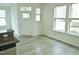Bright living room features hardwood floors, modern ceiling fan and plentiful natural light from the windows at 1725 Mallard Trace Dr, Wendell, NC 27591