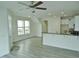 Bright living room features hardwood floors, modern ceiling fan and plentiful natural light from the windows at 1725 Mallard Trace Dr, Wendell, NC 27591