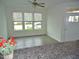 Bright living room features hardwood floors, modern ceiling fan and plentiful natural light from the windows at 1725 Mallard Trace Dr, Wendell, NC 27591