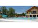 Resort-style pool and clubhouse featuring water slide and shaded seating areas at 1725 Mallard Trace Dr, Wendell, NC 27591