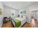 A comfortable bedroom with warm hardwood floors, a window, white bedding, and decor at 184 Mort Harris Rd, Louisburg, NC 27549