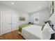 A spacious bedroom with warm hardwood floors, white bedding, and decor at 184 Mort Harris Rd, Louisburg, NC 27549