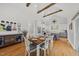 Open-concept area with dining table, kitchen, and hallway with stainless steel refrigerator at 184 Mort Harris Rd, Louisburg, NC 27549
