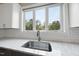 Kitchen detail featuring a stainless steel sink, subway tile backsplash, and a bright window at 184 Mort Harris Rd, Louisburg, NC 27549