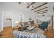 Inviting living room featuring vaulted ceilings with wooden beams, hardwood floors, and an open floor plan at 184 Mort Harris Rd, Louisburg, NC 27549