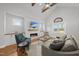 Comfortable living room with a fireplace, modern furnishings, hardwood floors, and lots of natural light at 184 Mort Harris Rd, Louisburg, NC 27549
