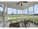 Relaxing screened porch showcasing comfortable seating and scenic views of the expansive backyard and beyond at 184 Mort Harris Rd, Louisburg, NC 27549