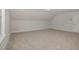Upstairs bonus room showcases soft natural light and neutral walls and carpeting at 198 Ruskin Dr, Smithfield, NC 27577
