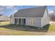 Rear exterior view shows the home, screened-in porch, and manicured lawn at 198 Ruskin Dr, Smithfield, NC 27577