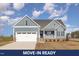 Charming home showcases a two-car garage, stone accents, and a welcoming front porch at 198 Ruskin Dr, Smithfield, NC 27577