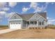 Beautiful exterior of home features a two-car garage and covered porch at 198 Ruskin Dr, Smithfield, NC 27577