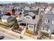 Aerial view of a two-story home with solar panels, a front porch, landscaped yard, and surrounding neighborhood at 1980 Great Ridge Pkwy, Chapel Hill, NC 27516
