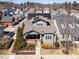 Aerial view of a two-story home with solar panels, a front porch, landscaped yard, and surrounding neighborhood at 1980 Great Ridge Pkwy, Chapel Hill, NC 27516
