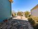 Charming backyard with a stone patio, well-manicured greenery, and view of neighboring houses at 1980 Great Ridge Pkwy, Chapel Hill, NC 27516