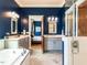 Bathroom features double vanity sinks, soaking tub, glass shower, and blue accent walls at 1980 Great Ridge Pkwy, Chapel Hill, NC 27516