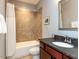 Bathroom features a tiled shower and tub, vanity with sink and silver-framed mirror at 1980 Great Ridge Pkwy, Chapel Hill, NC 27516