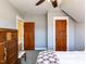 Cozy bedroom featuring a ceiling fan, two wooden doors and a decorative dresser at 1980 Great Ridge Pkwy, Chapel Hill, NC 27516