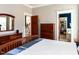 Neutral toned bedroom featuring wood floors, a wood dresser, and views to other rooms at 1980 Great Ridge Pkwy, Chapel Hill, NC 27516