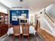 Lovely dining room boasting hardwood floors, blue accent wall, fireplace, and staircase access at 1980 Great Ridge Pkwy, Chapel Hill, NC 27516